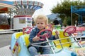 A little boy playing in a fun fair carousel Royalty Free Stock Photo