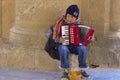 Little boy playing harmonica in Rhodes town, Greece
