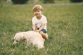 Little boy playing with his dog on a grass Royalty Free Stock Photo