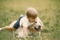 Little boy playing with his dog on a grass Royalty Free Stock Photo