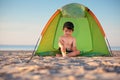 Little boy playing in his tent on the beach Royalty Free Stock Photo