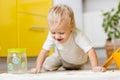 Little boy playing with kitchenware and foodstuffs in kitchen