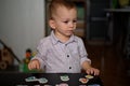 Little boy playing with letters and numbers on a table Royalty Free Stock Photo