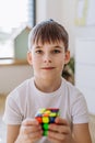 Little boy playing with logic cube in his room.