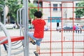 Little boy playing on monkey bars at playground Royalty Free Stock Photo