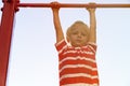 Little boy playing on monkey bars in playground Royalty Free Stock Photo