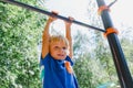 Little boy playing on monkey bars at playground Royalty Free Stock Photo