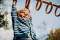 Little boy playing on monkey bars at playground Royalty Free Stock Photo