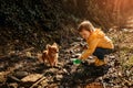 Little boy playing in a muddy puddle with his dog Royalty Free Stock Photo