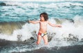 Little boy playing in outdoor jumping into water on summer vacation on tropical beach island. Happy child playing in the Royalty Free Stock Photo