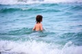 Little boy playing in outdoor jumping into water on summer vacation on tropical beach island. Royalty Free Stock Photo