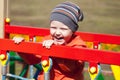 Little boy playing on the playground in the autumn park Royalty Free Stock Photo