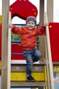 Little boy playing on the playground in the autumn park Royalty Free Stock Photo