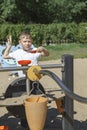 Little boy playing on a playground with sand on a sunny summer day Royalty Free Stock Photo