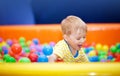 Little boy playing on playroom with ballpit Royalty Free Stock Photo