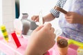 Little boy playing pretend as a saler in icecream shop store