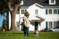 Little boy playing with puppy. Happy child walking dog. Royalty Free Stock Photo