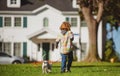 Little boy playing with puppy. Happy child walking dog. Royalty Free Stock Photo