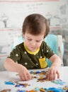 Little boy playing puzzle