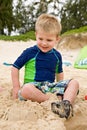 Little Boy Playing in Sand at the Beach