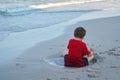 A little boy playing in the sand. Lying in a sand puddle. play in the mud.