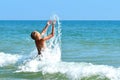 A little boy playing in the sea water. A child jumps from the sea. A tropical vacation with children. Royalty Free Stock Photo