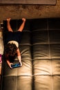 Little boy playing smartphone while lying at home Royalty Free Stock Photo