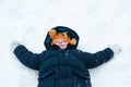 Little boy playing snow angels Royalty Free Stock Photo