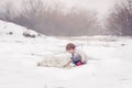 Little boy playing in the snow