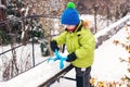 Little boy playing with snowball maker outdoors. Winter fun games at snowy day. Happy winter holidays. Popular toy for kid for Royalty Free Stock Photo