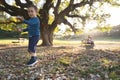 A little boy playing with soap bubbles and his parents watching him in the distanse Royalty Free Stock Photo