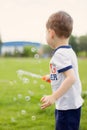little boy playing with soap bubbles. summer street games in the park. Royalty Free Stock Photo