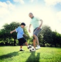 Little Boy Playing Soccer With His Father Concept