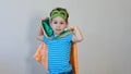 Little boy playing a superhero. Kid in an Superhero`s costume. happy child. green mask, nature care concept Royalty Free Stock Photo