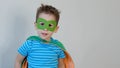 Little boy playing a superhero. Kid in an Superhero`s costume. happy child. green mask, nature care concept Royalty Free Stock Photo