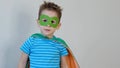 Little boy playing a superhero. Kid in an Superhero`s costume. happy child. green mask, nature care concept Royalty Free Stock Photo