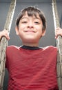 Little boy playing swing indoor rim light Royalty Free Stock Photo