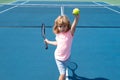 Little boy playing tennis. Sport kids. Child with tennis racket on tennis court. Training for young kid, healthy Royalty Free Stock Photo