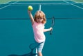 Little boy playing tennis. Sport kids. Child with tennis racket on tennis court. Training for young kid, healthy Royalty Free Stock Photo