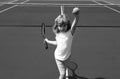 Little boy playing tennis. Sport kids. Child with tennis racket on tennis court. Training for young kid, healthy Royalty Free Stock Photo