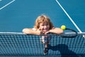 Little boy playing tennis. Sport kids, thumbs up, winner. Child with tennis racket on tennis court. Training for young Royalty Free Stock Photo