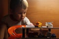 Little boy playing toy cars. Child driving car to parking garage. Kids at home Royalty Free Stock Photo