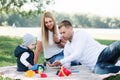 Little boy playing toy cars and having fun with his father and mother outdoors Royalty Free Stock Photo