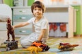 Little boy playing toy cars on play mat. Young kid with colorful educational vehicle and transport toys on carpet. City Royalty Free Stock Photo