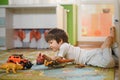 Little boy playing toy cars on play mat. Young kid with colorful educational vehicle and transport toys on carpet. City Royalty Free Stock Photo