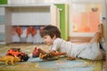 Little boy playing toy cars on play mat. Young kid with colorful educational vehicle and transport toys on carpet. City street map Royalty Free Stock Photo