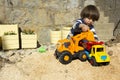 Little boy playing with toy digger and dumper truck. Royalty Free Stock Photo