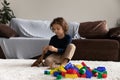 Little boy playing with toy dinosaur, sitting on warm floor Royalty Free Stock Photo