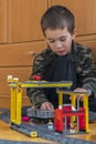 Little boy playing with a toy railway. Little boy playing with railway lying on the floor. Joyful emotions. vertical photo Royalty Free Stock Photo