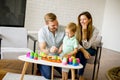 Little boy playing toys with mother and father at home Royalty Free Stock Photo